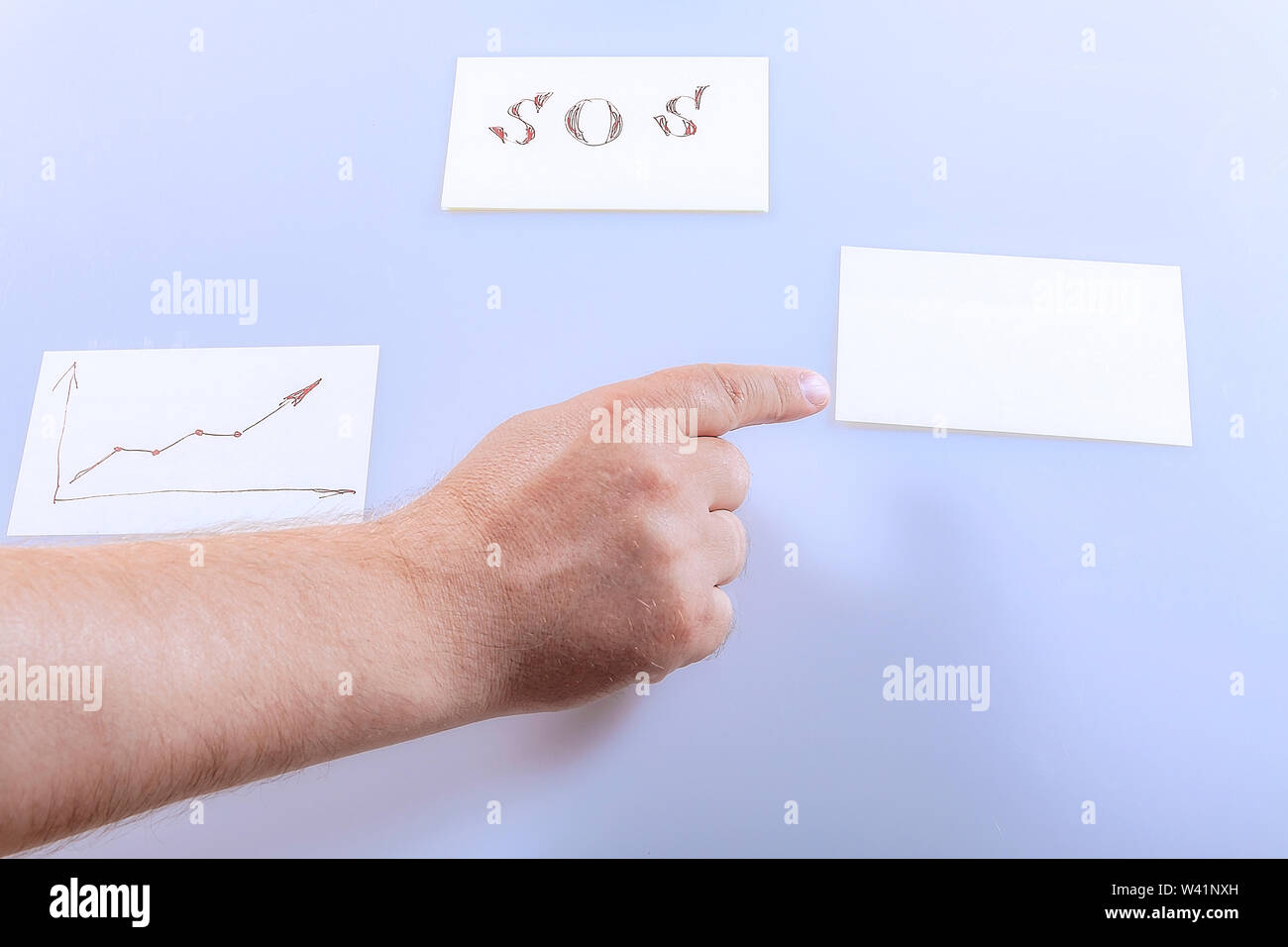 The finger on the hand shows a blank sticker. Template. Stock Photo