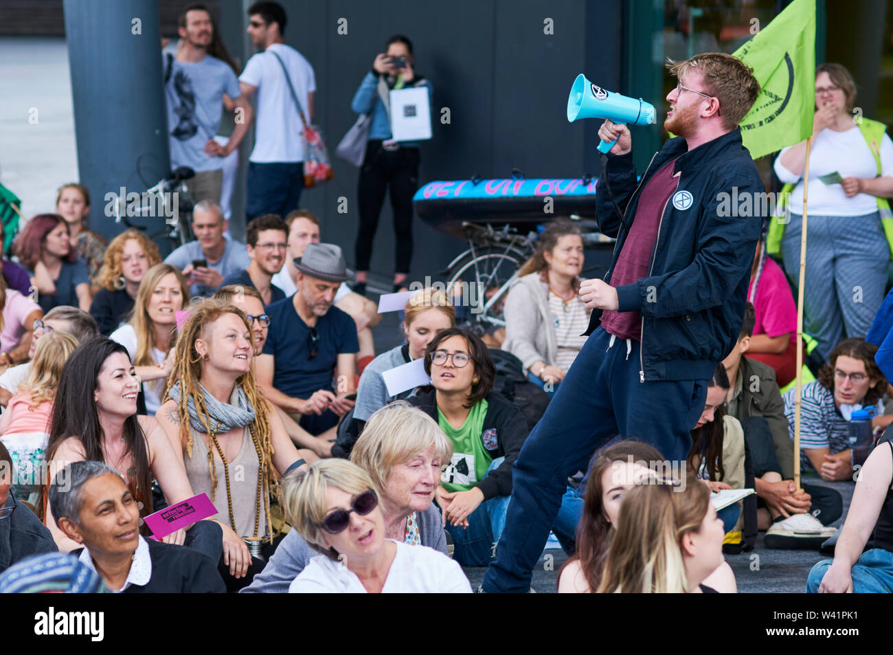 A speaker addressing the crowd at an Extinction Rebellion protest outside City Hall, London UK, on the 18th July 2019 Stock Photo