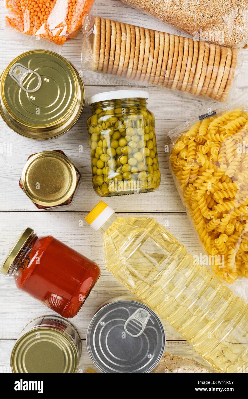 Assortment of grains, cereals and pasta in glass jars on wooden