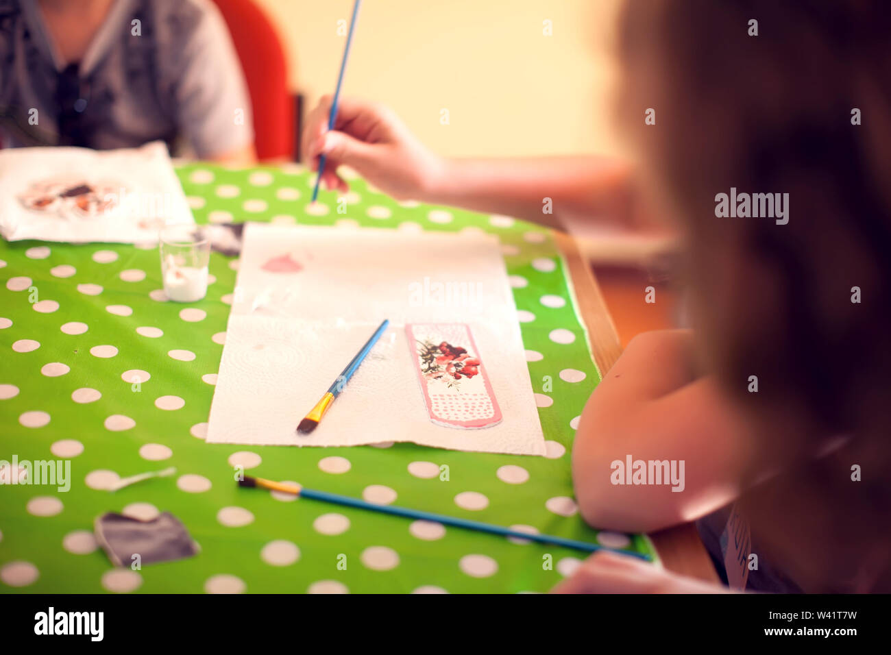 Children hands making artworks with wood and paint crafts. workplace
