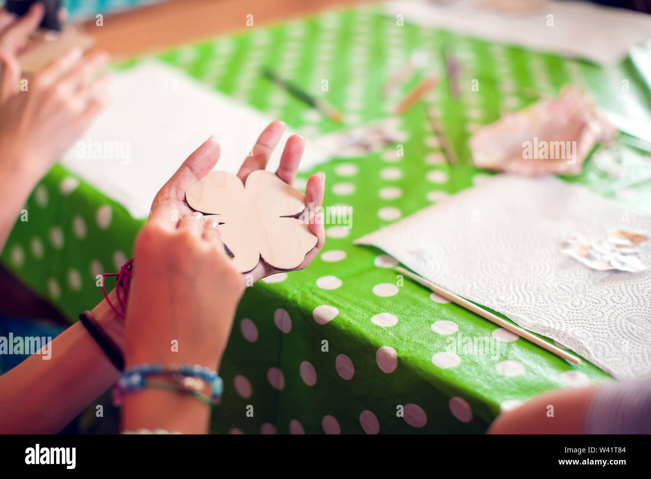 Children hands making artworks with wood and paint crafts. workplace