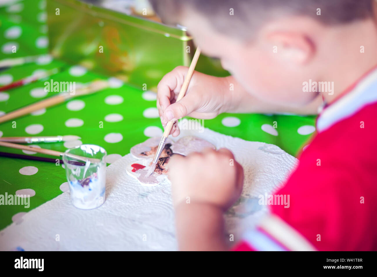 Children hands making artworks with wood and paint crafts. workplace