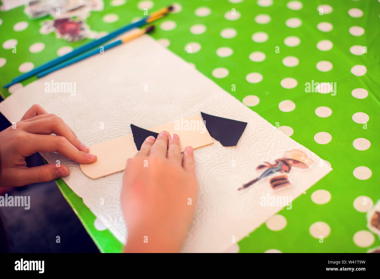Children hands making artworks with wood and paint crafts. workplace