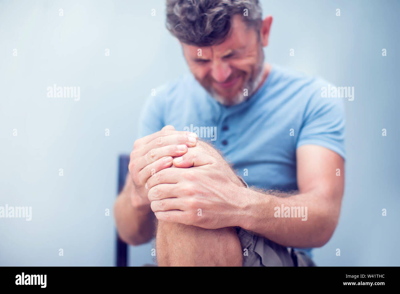 Man with knee pain close up. Pain relief concept Stock Photo