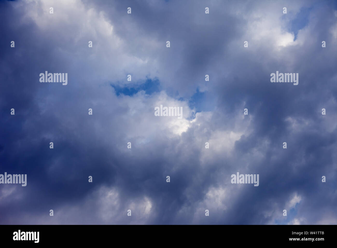 Dramatic thunder storm clouds at dark sky with sun rays Stock Photo - Alamy