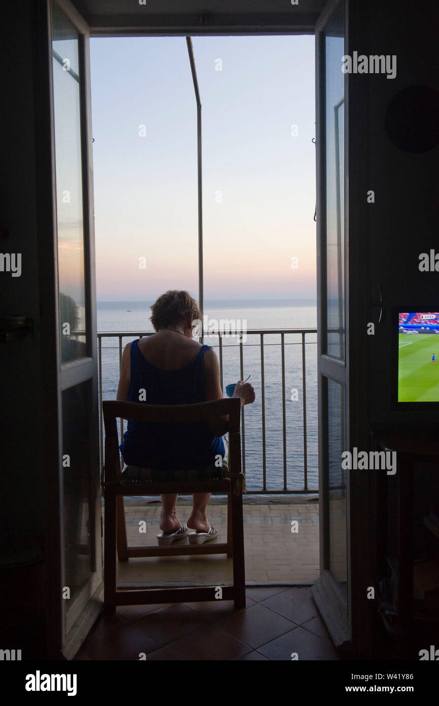Woman watching sunset balcony hi-res stock photography and images - Alamy