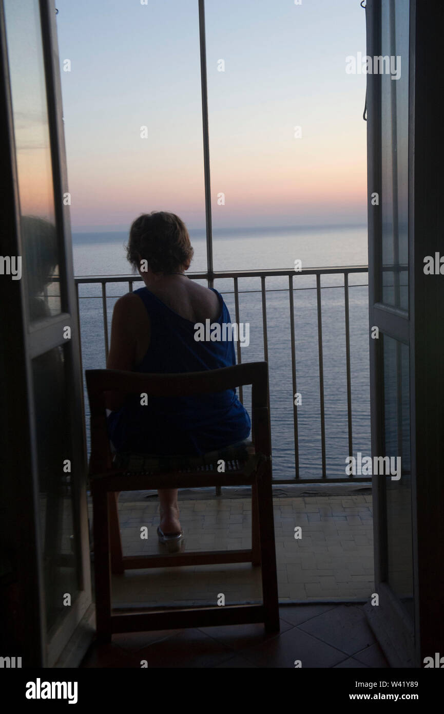 Woman watching sunset balcony hi-res stock photography and images - Alamy
