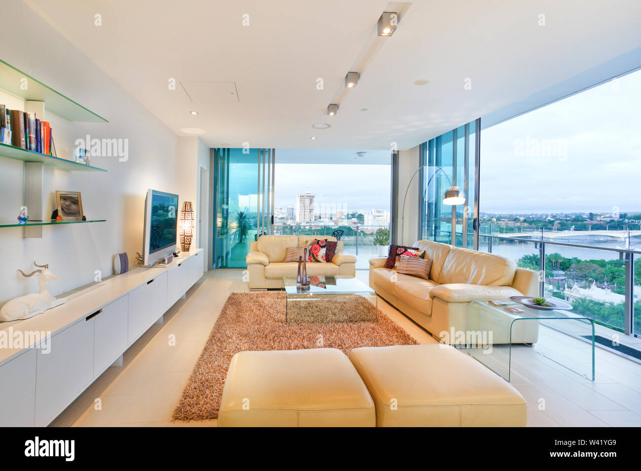 Clean living area with television, comfortable furnitures and designs