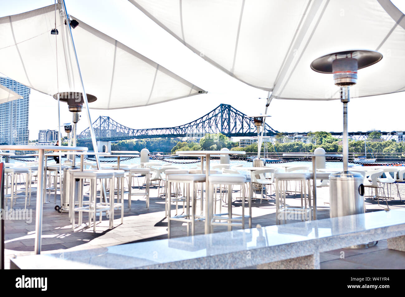 Outside patio or relaxing area with white chairs and tables that covered with tent beside river of Brisbane City, Queensland, Australia. Stock Photo