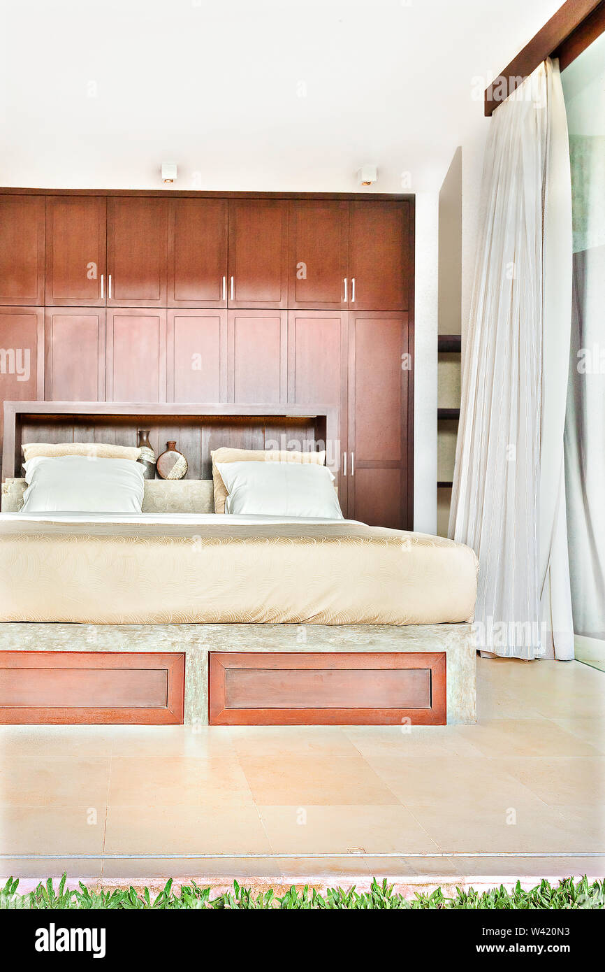 Modern Bedroom With Wooden Cabinets Attached To The Wall And