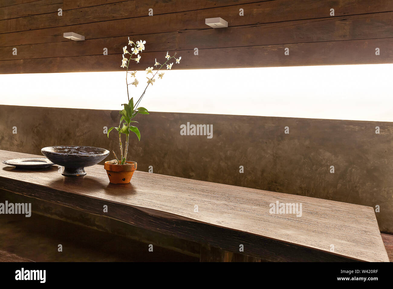 Flowering Plant In A Vase And Other Fancy Items On The Wooden