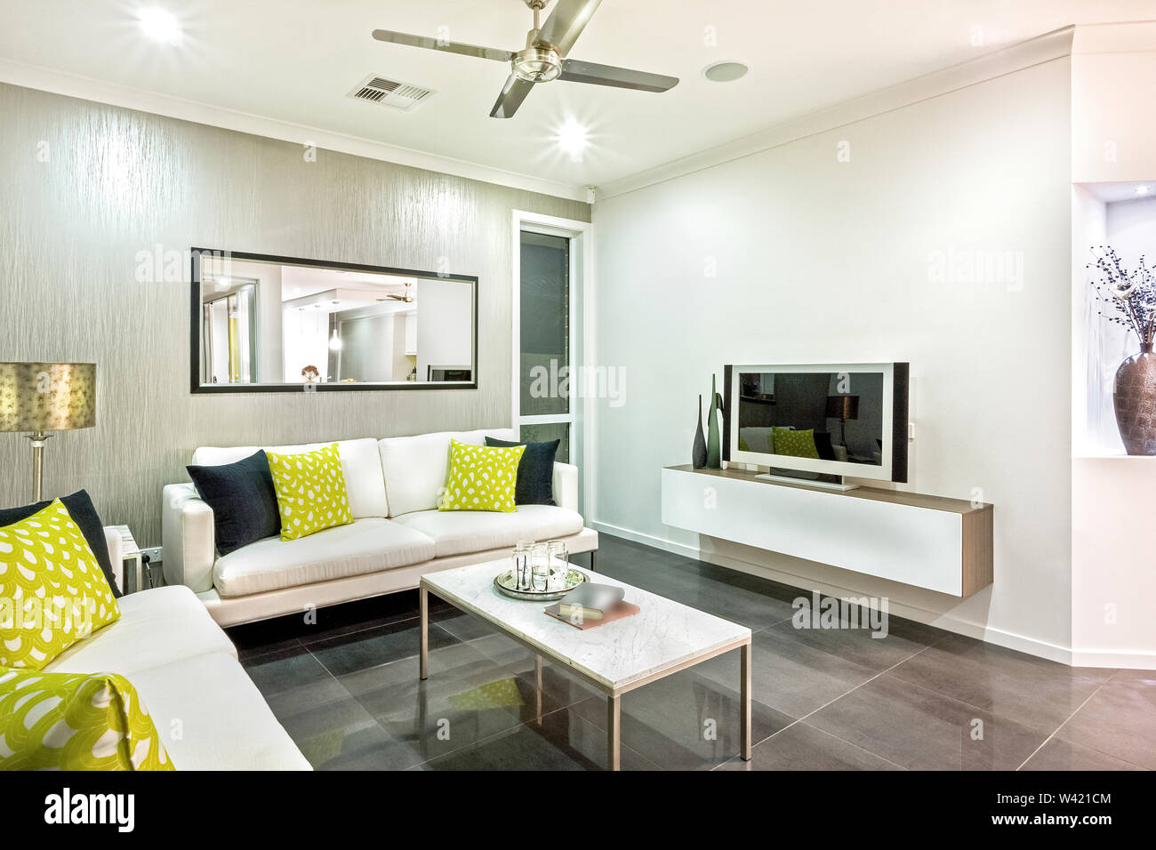 Designer living space with sofa sets, a center table, a fan, ceiling