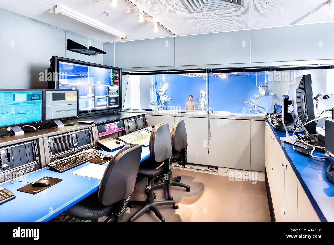 Broadcasting studio with screens and other editing equipment with no people ready to start broadcasting from the outside room with cameras Stock Photo
