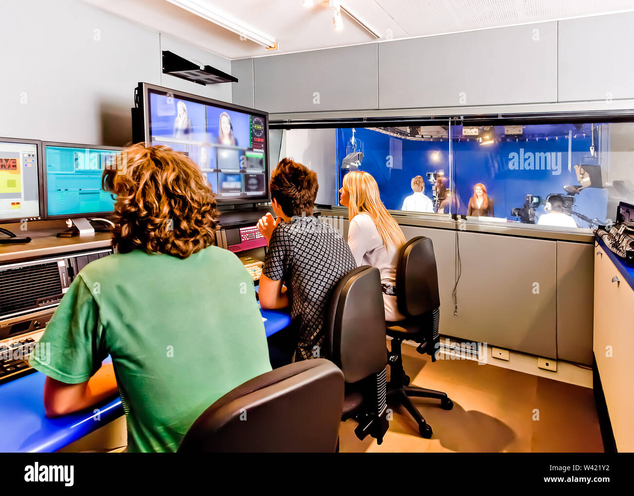 People are working in a broadcasting studio with monitors and mixers to lead their cameras and programs Stock Photo