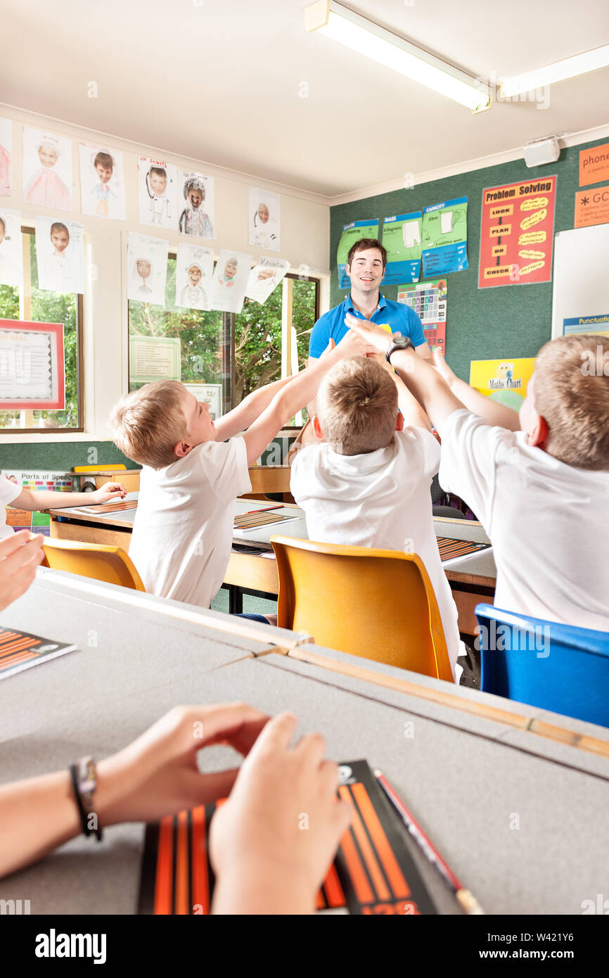 Teacher play games with kids in the classroom, students move their