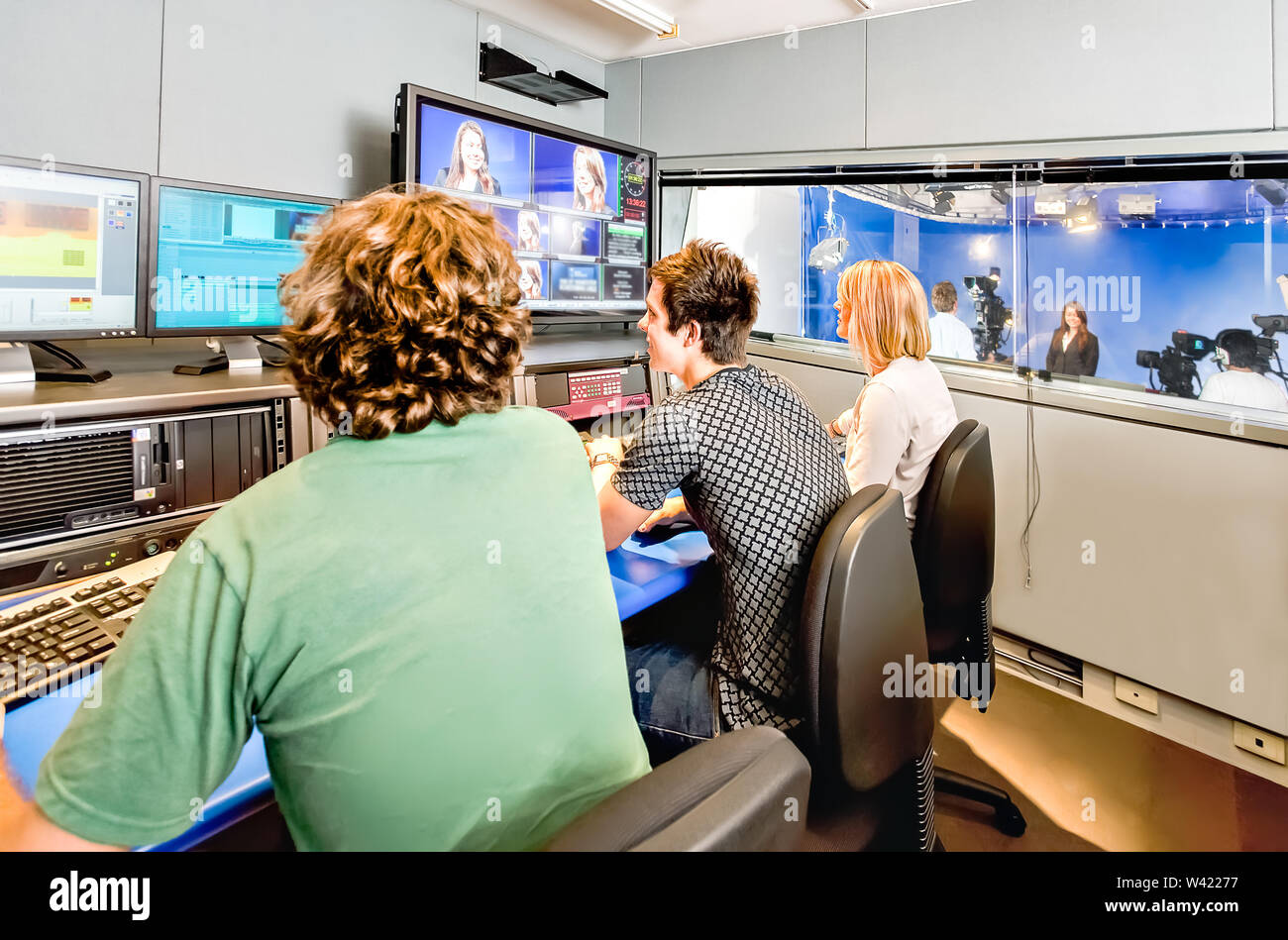 University students learn how to manage a live program and broadcasting in a modern studio Stock Photo