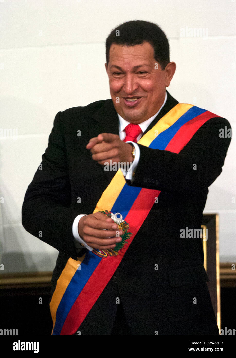 Venezuelan President Hugo Chavez, wearing a Venezuelan flag, sends a kiss during his investiture as President of Venezuela in Caracas Stock Photo