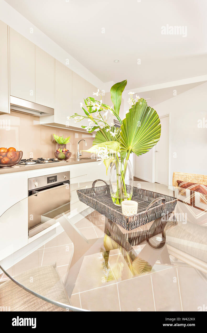 Fresh flower pot on glass table near kitchen, oven and gas cooker have  attached to the pantry cupboard, ceramics and fruits close to cookers,  flowers Stock Photo - Alamy