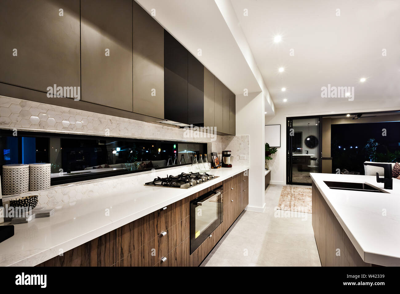 Modern cooking area, including a stove beside oven and countertop near