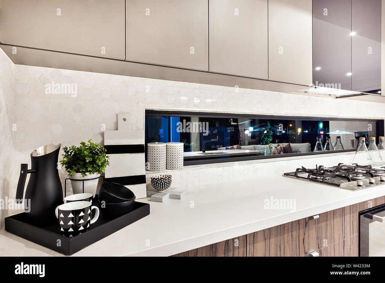 Kitchenware on the countertop next to stove in a modern cooking area