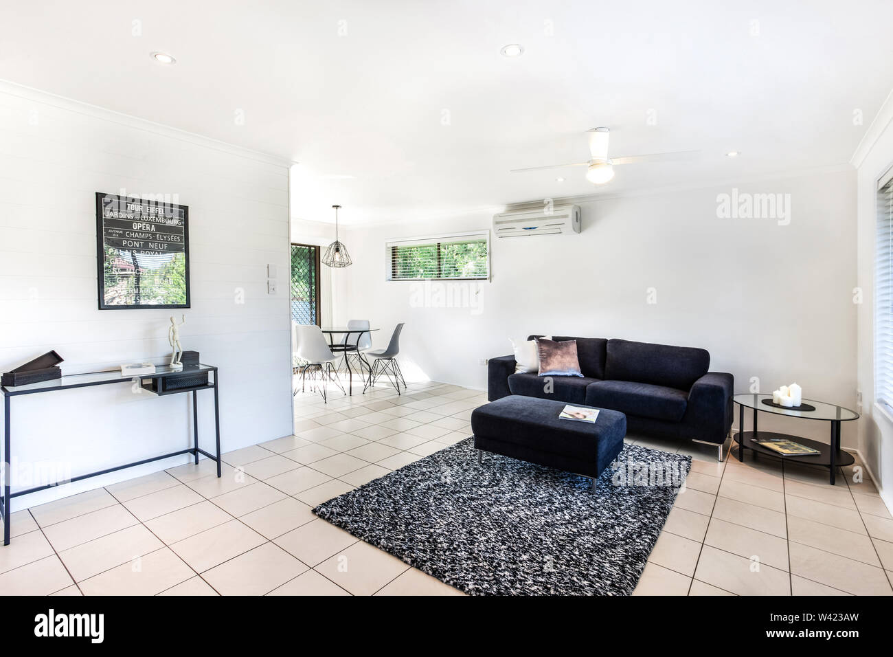 A large living room area featuring a contemporary style footrest lounge sofa, a showpiece table