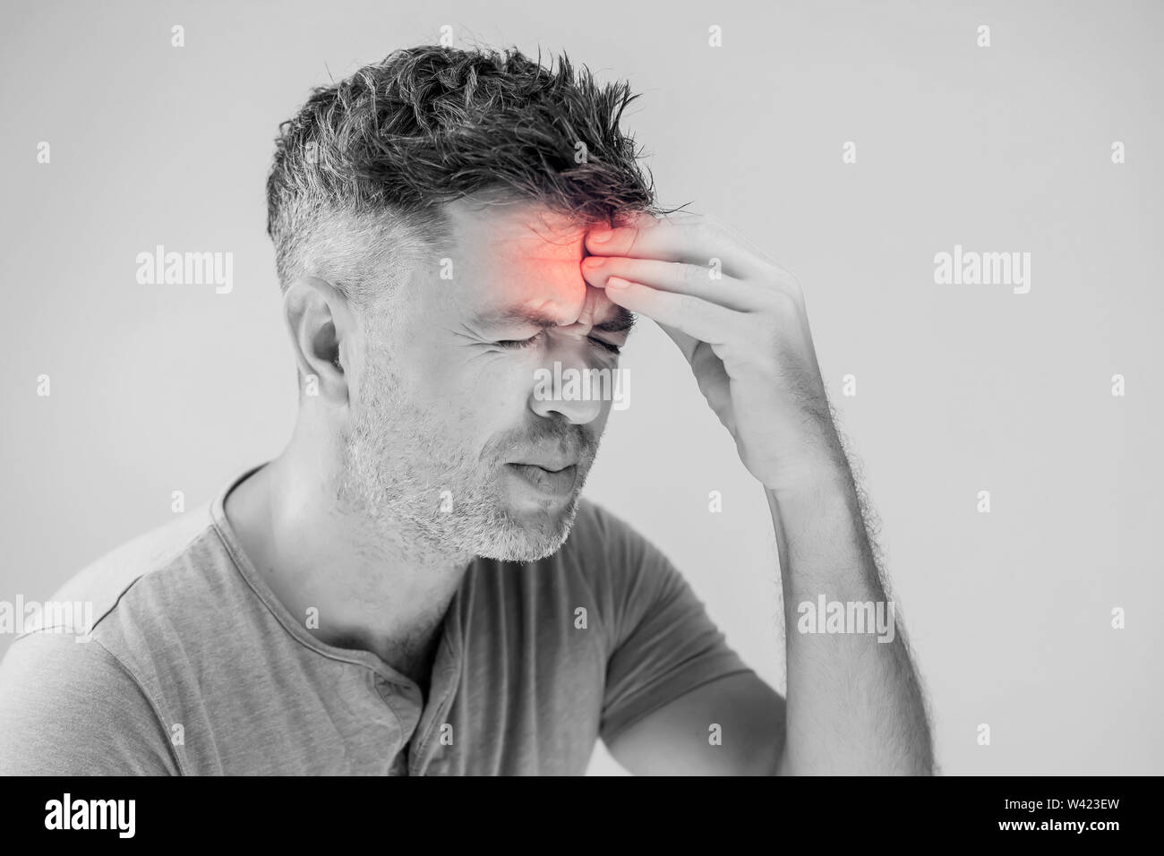 Handsome young man suffering from headache Stock Photo