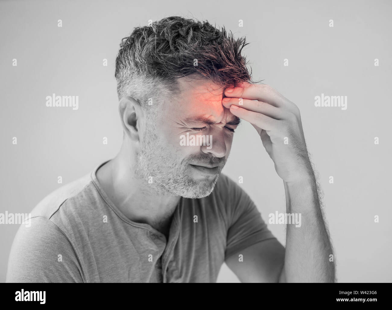 Handsome young man suffering from headache Stock Photo