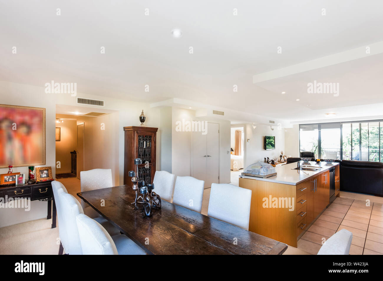 A gothic style dinner table set near the kitchen area with large