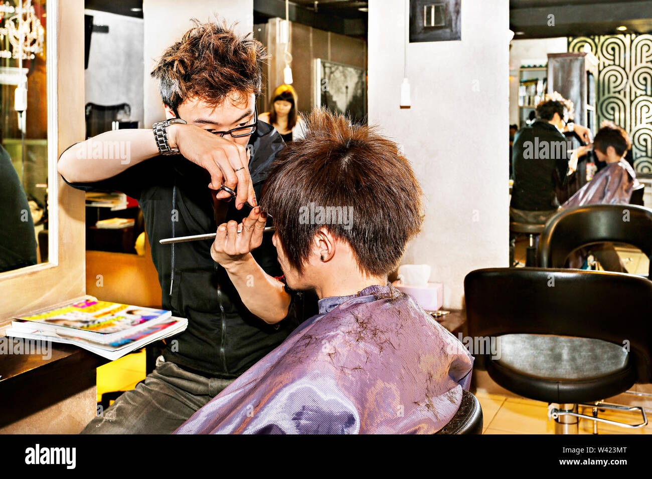 Hairdresser Cutting Boys Hair In Stock Photos Hairdresser
