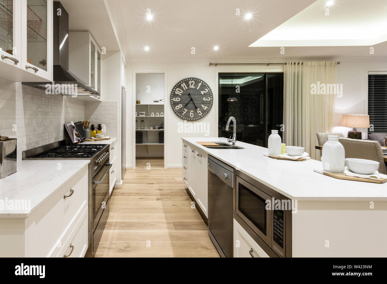 Luxury kitchen through the hallway to a another room between stoves