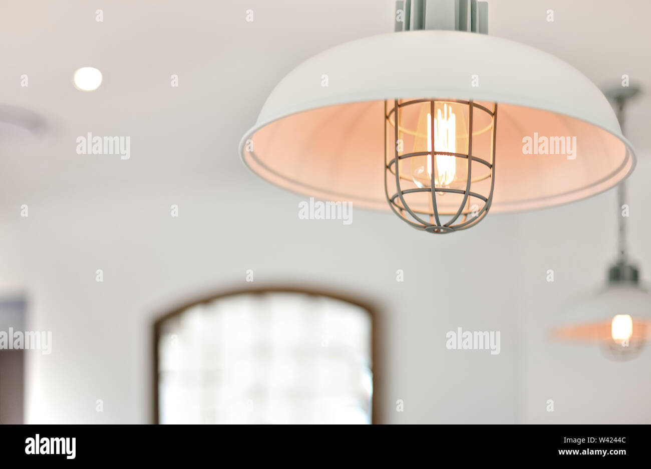 Light With A Round Plastic Cover Flashing With A Blurred Background Of A Room With White Walls Stock Photo Alamy