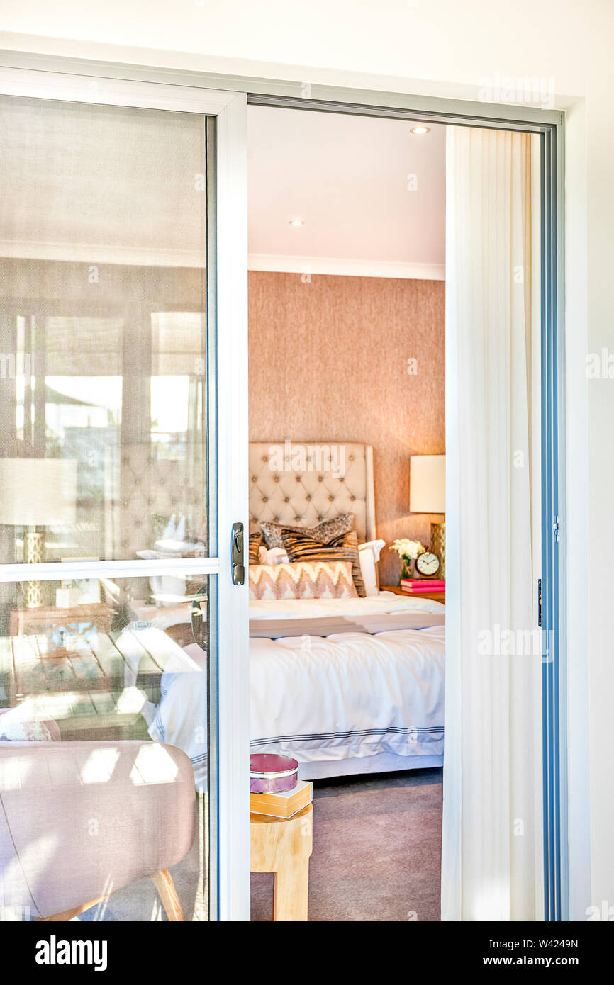 Luxury Bedroom Entrance With A Glass Door Open To The Inside