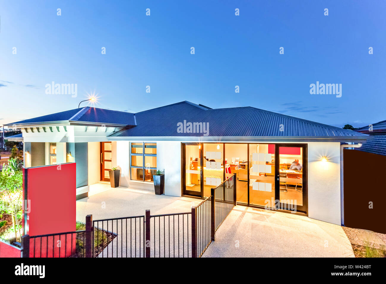 Luxurious House Facade With Flashing Lights Under Dark Sky Fence