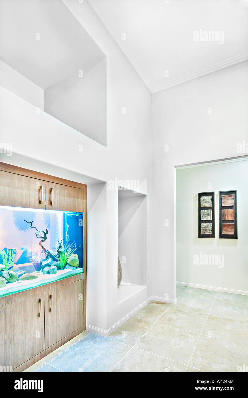 Fish Tank Near White Walls In Room Floor Is Tiled Evening
