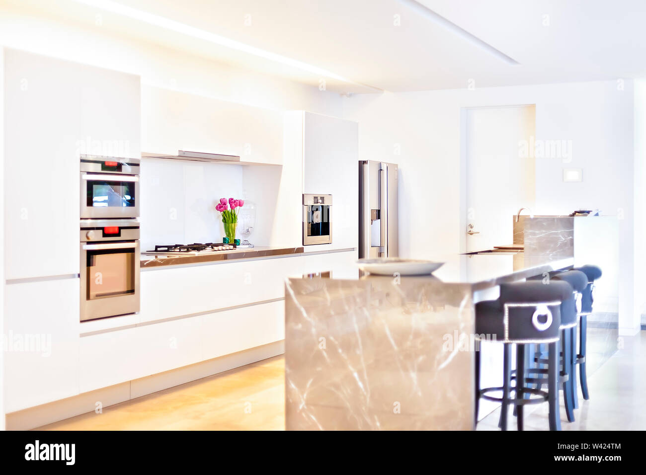 Modern kitchen ovens and stoves beside the refrigerator with white