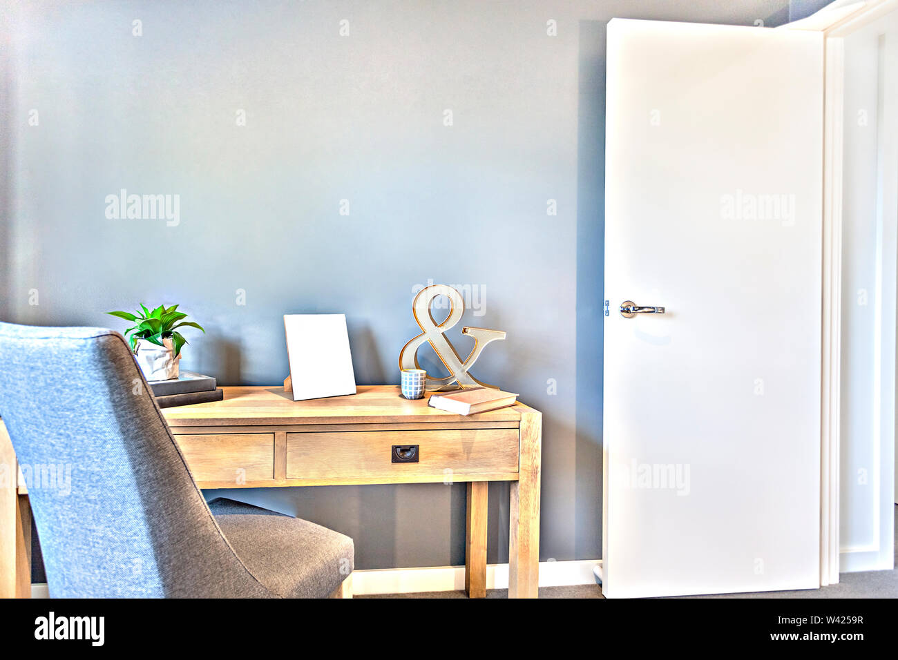 Workroom With A Door Entrance And Wooden Table Next To A