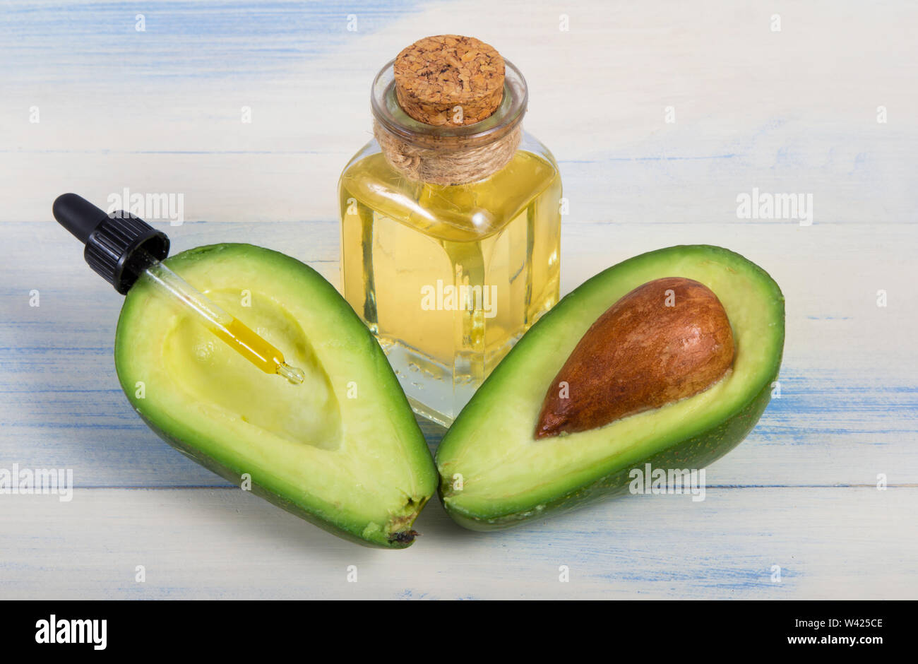 Avocado fruit and oil in glass bottle Stock Photo Alamy