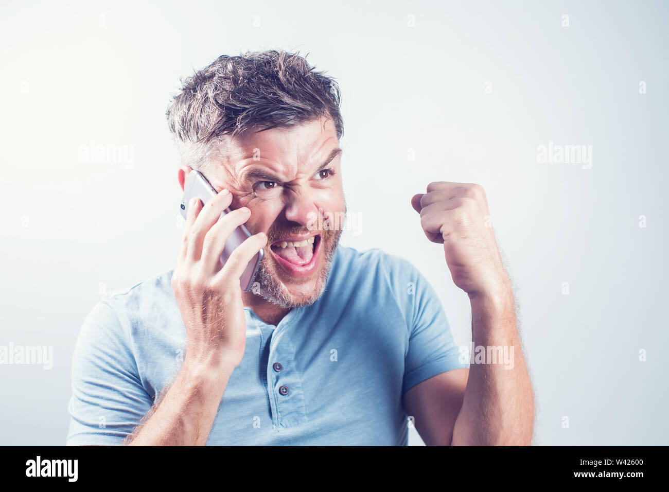 Handsome young man using mobile phone feel happy Stock Photo