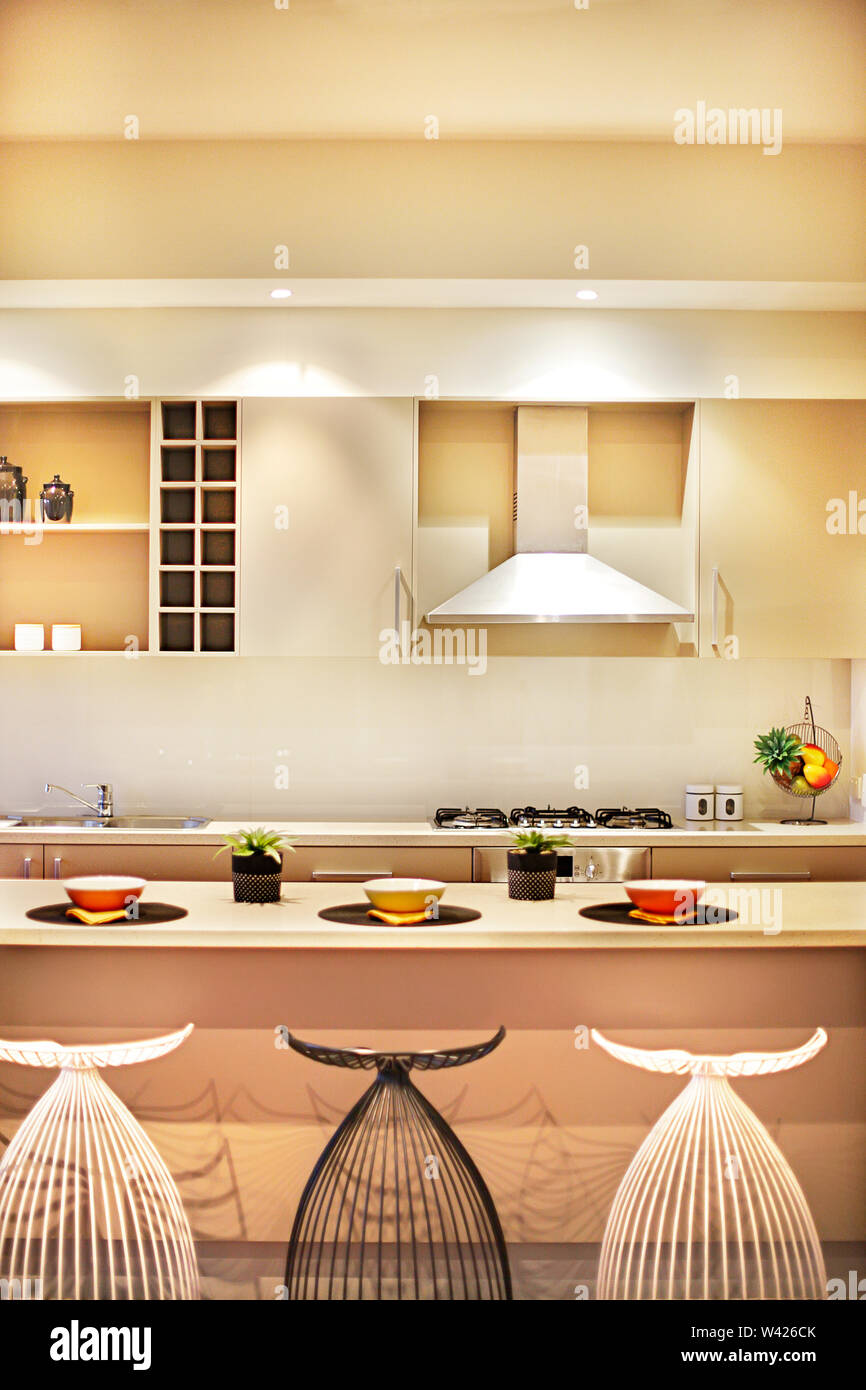 wallpapers Modern Chimney Design For Kitchen https www alamy com modern kitchen with creative chairs and counter top beside the stove under the silver chimney beside wall cupboard there are green plants with vase a image260663107 html