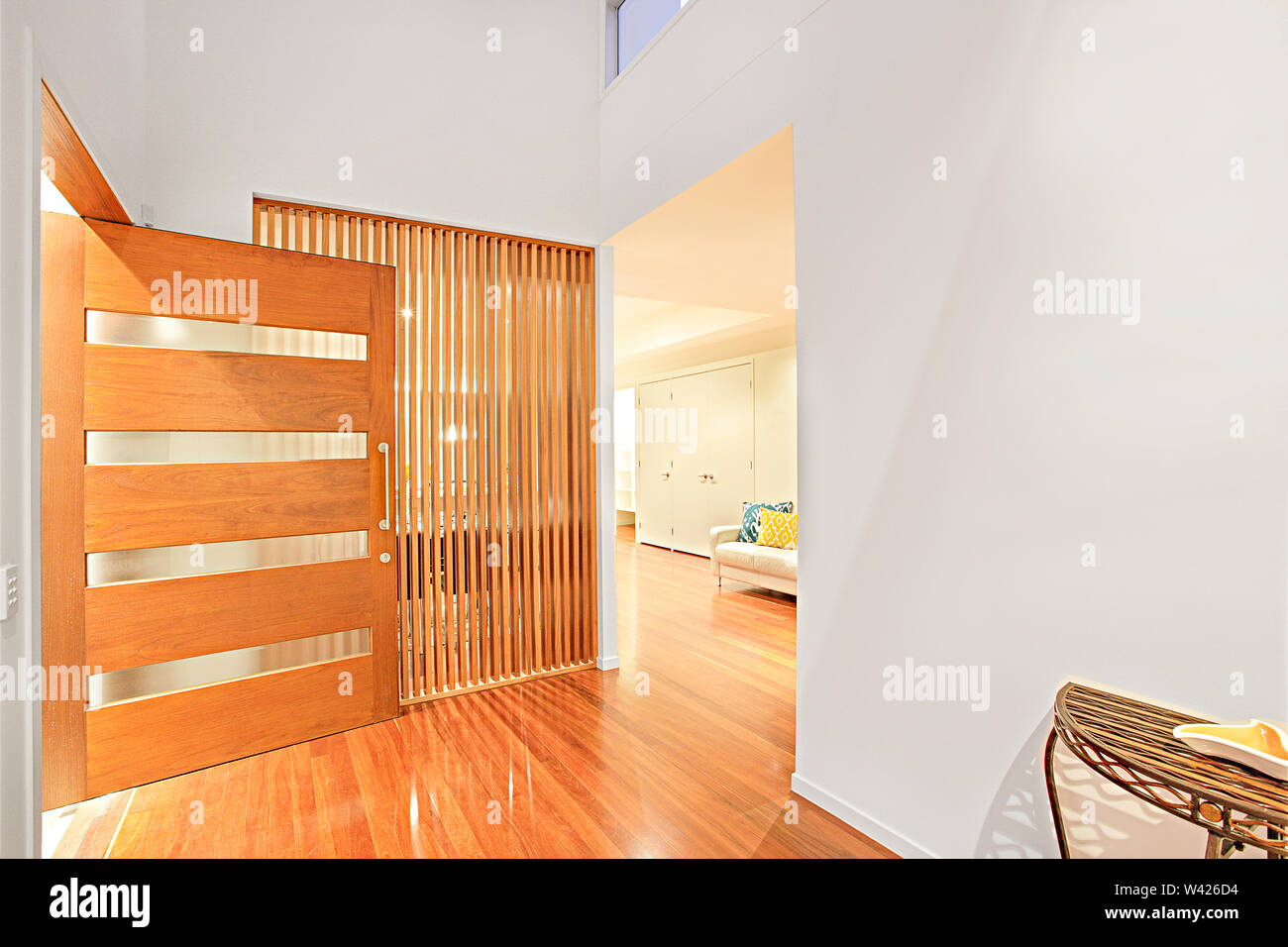 Colorful entrance and wooden door with designs, walls are painted with ...