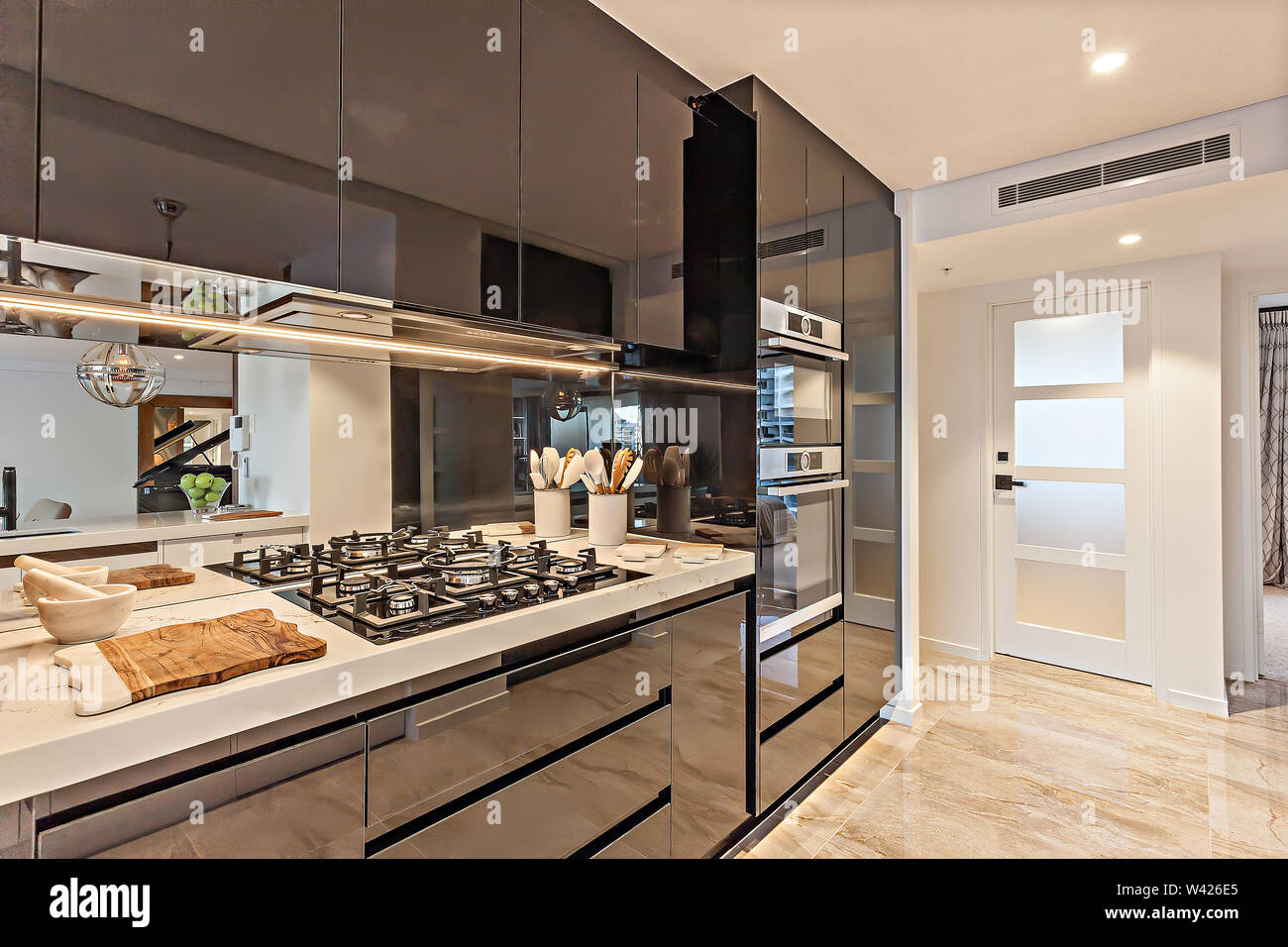 A Modern Kitchen Area With Designer Cabinets Electronic Equipment