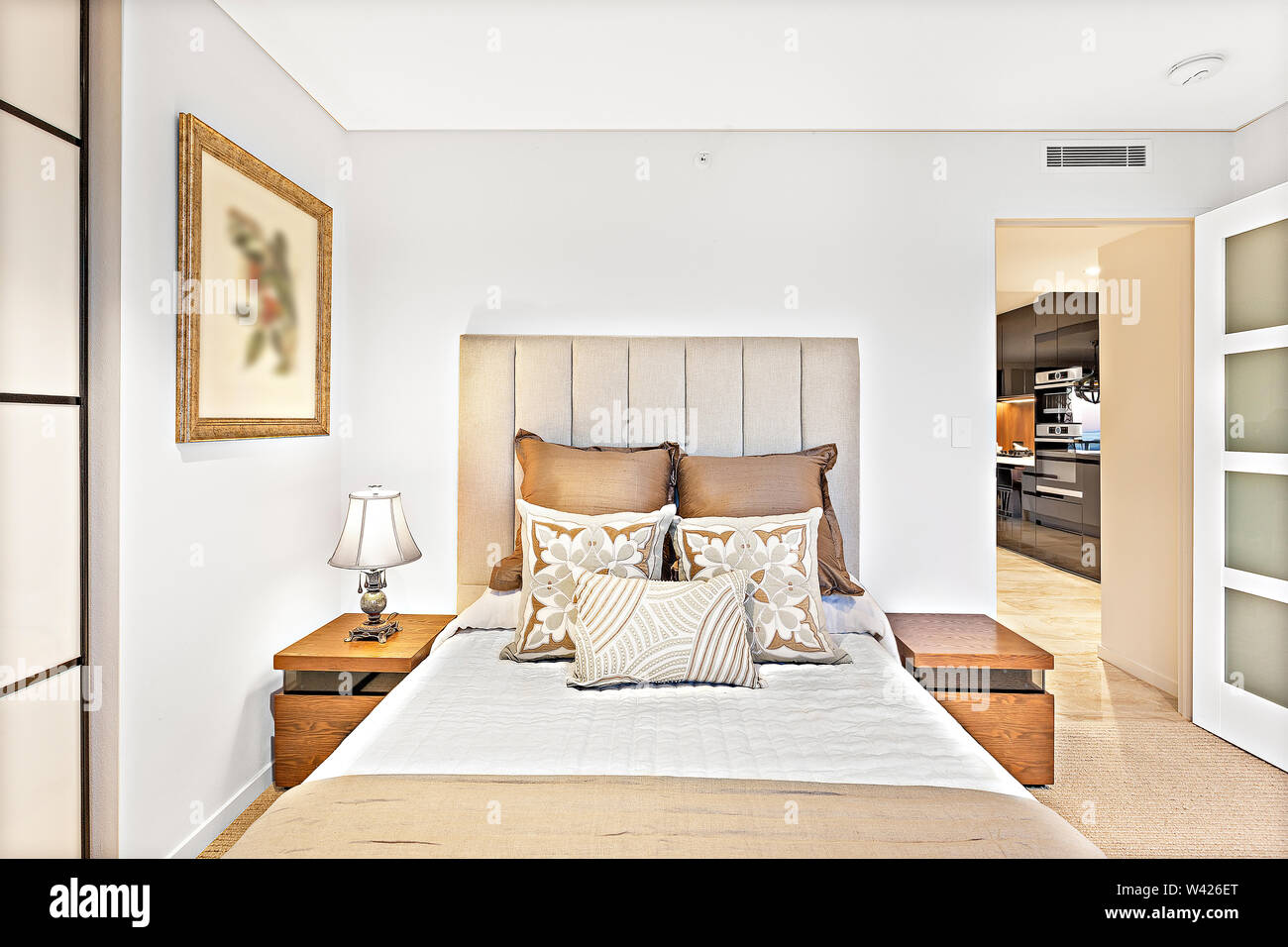 A cozy doublebed with plush cushions and side tables Stock Photo Alamy