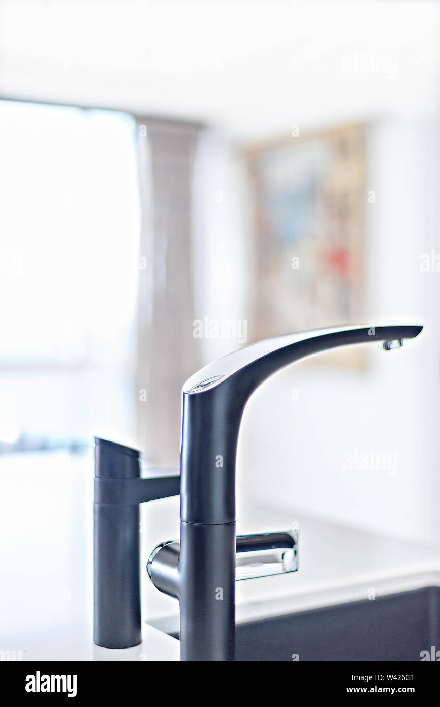 Sleek kitchen taps on the kitchen counter basin Stock Photo Alamy