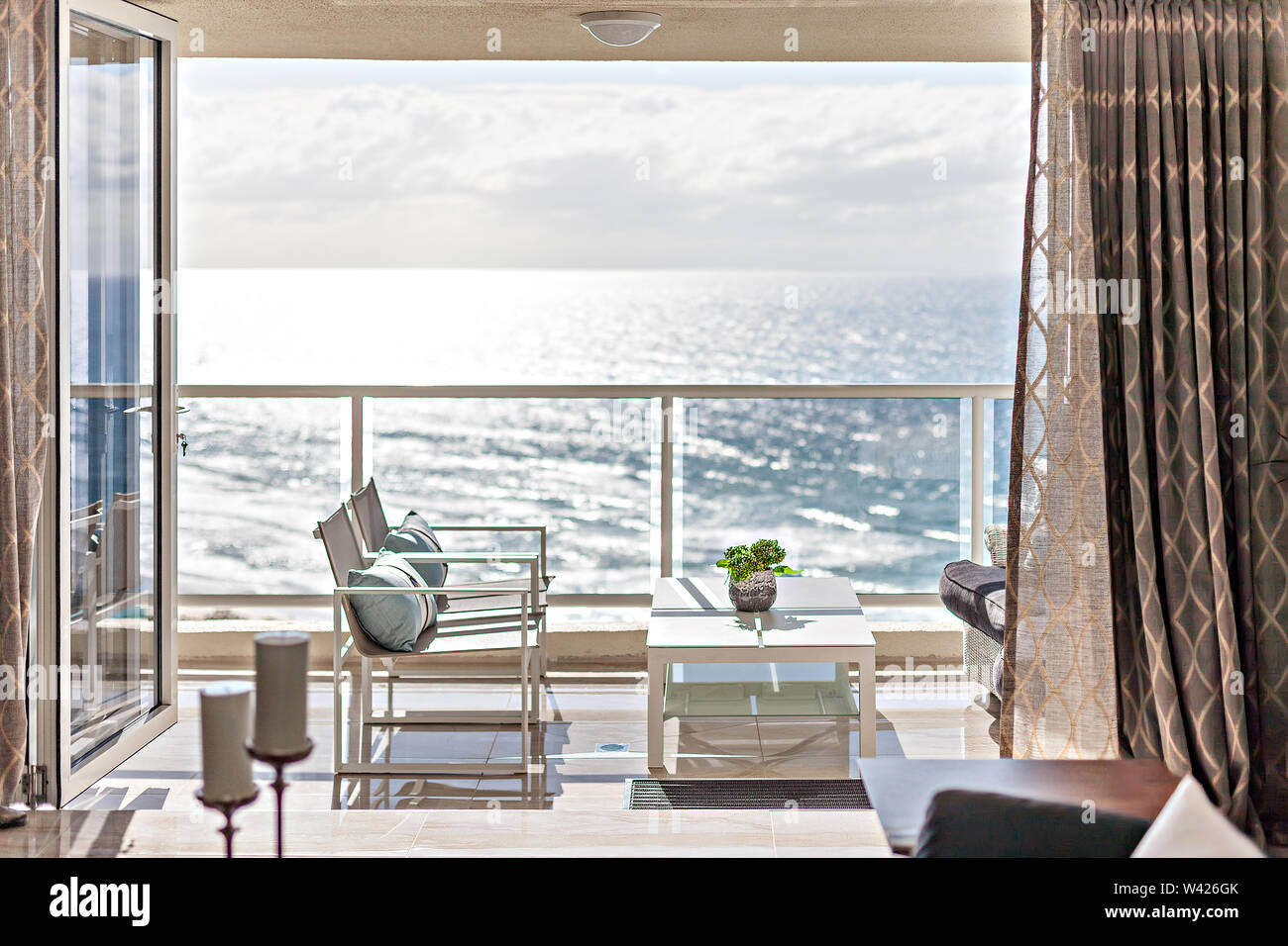 Relaxing balcony seating with a coffee table and sea in the background ...