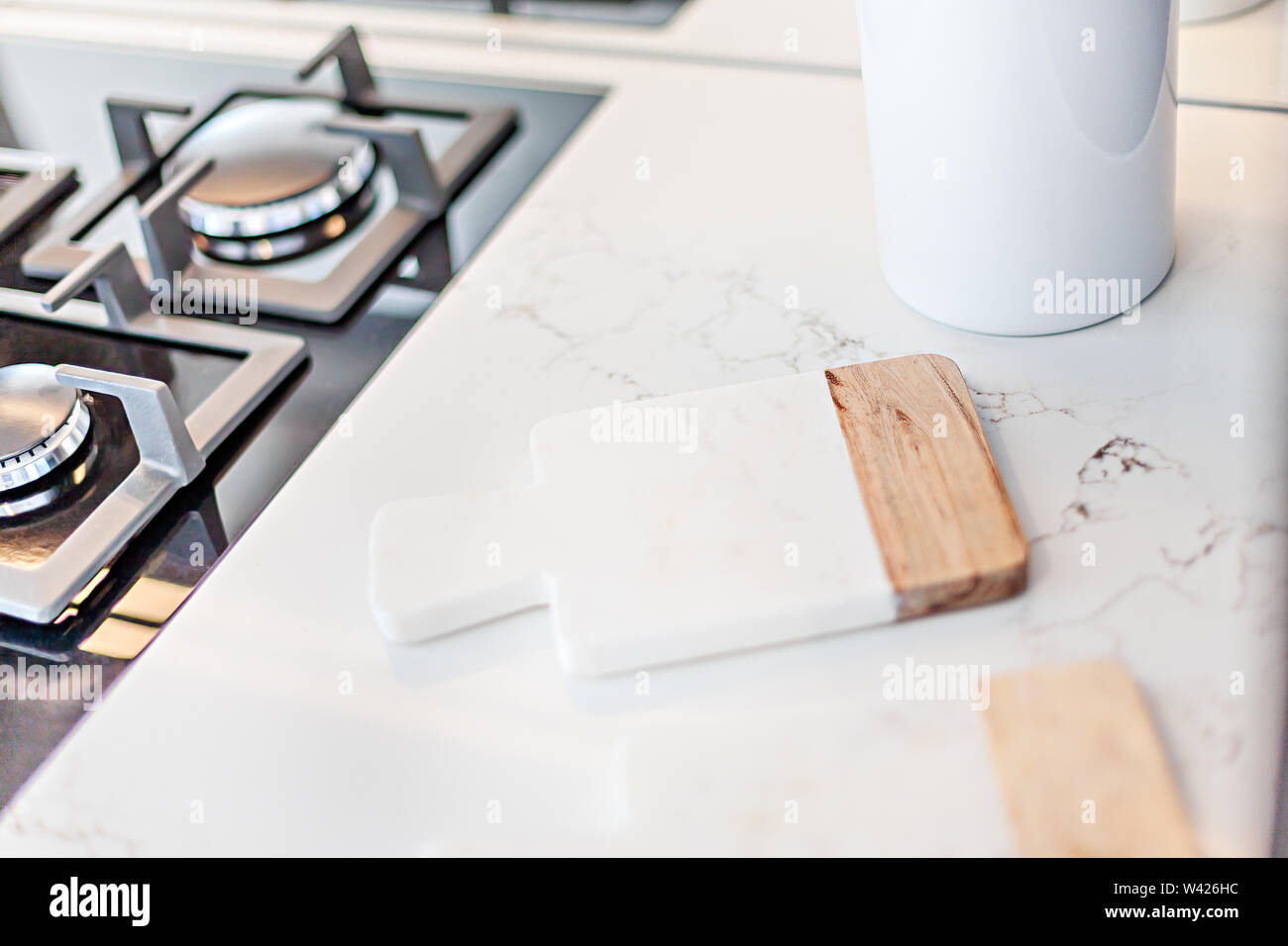 A neat chopping board placed near the gas hob Stock Photo Alamy