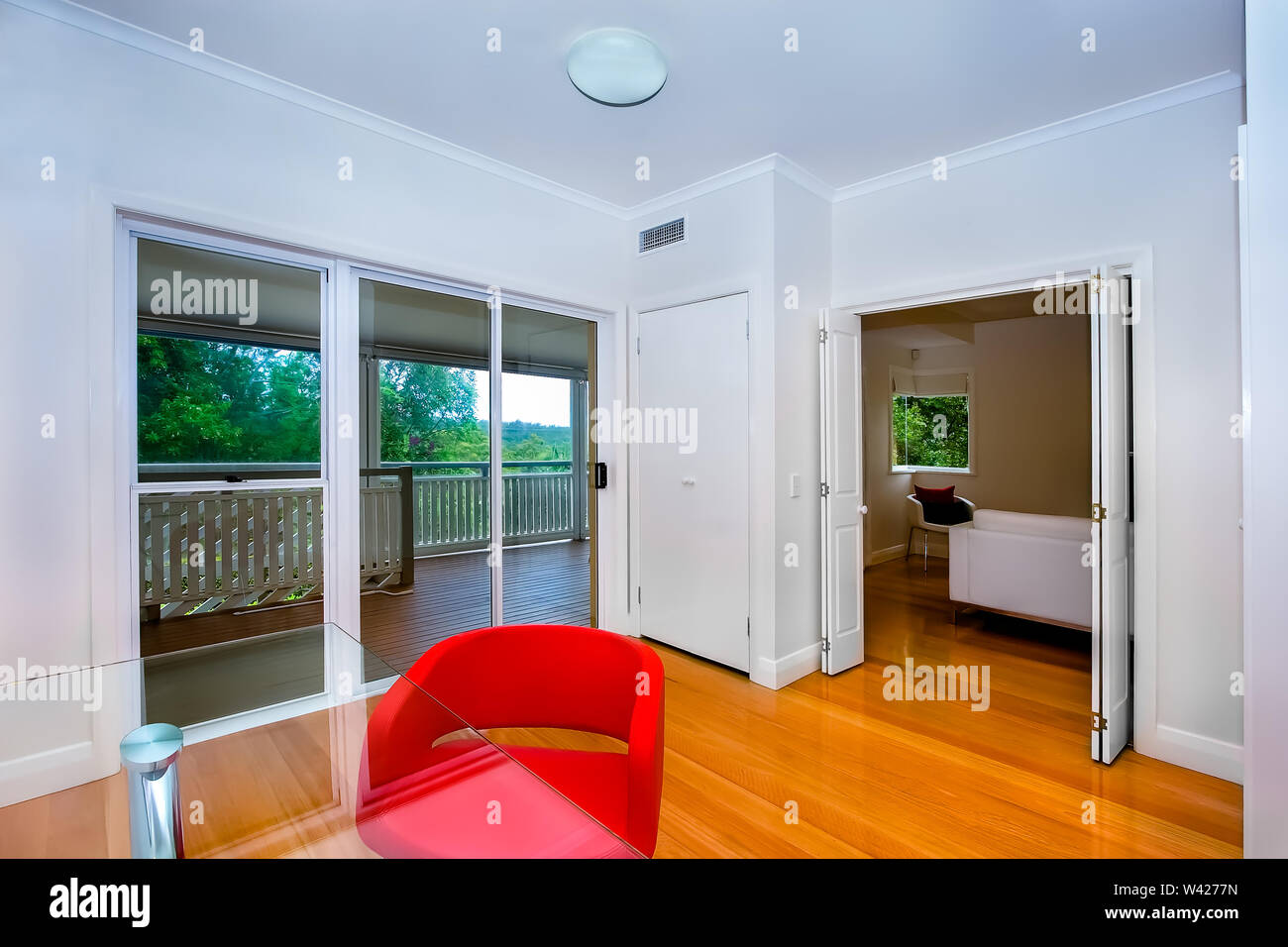 Two Connecting Rooms In A House With Wooden Floor And An Sliding