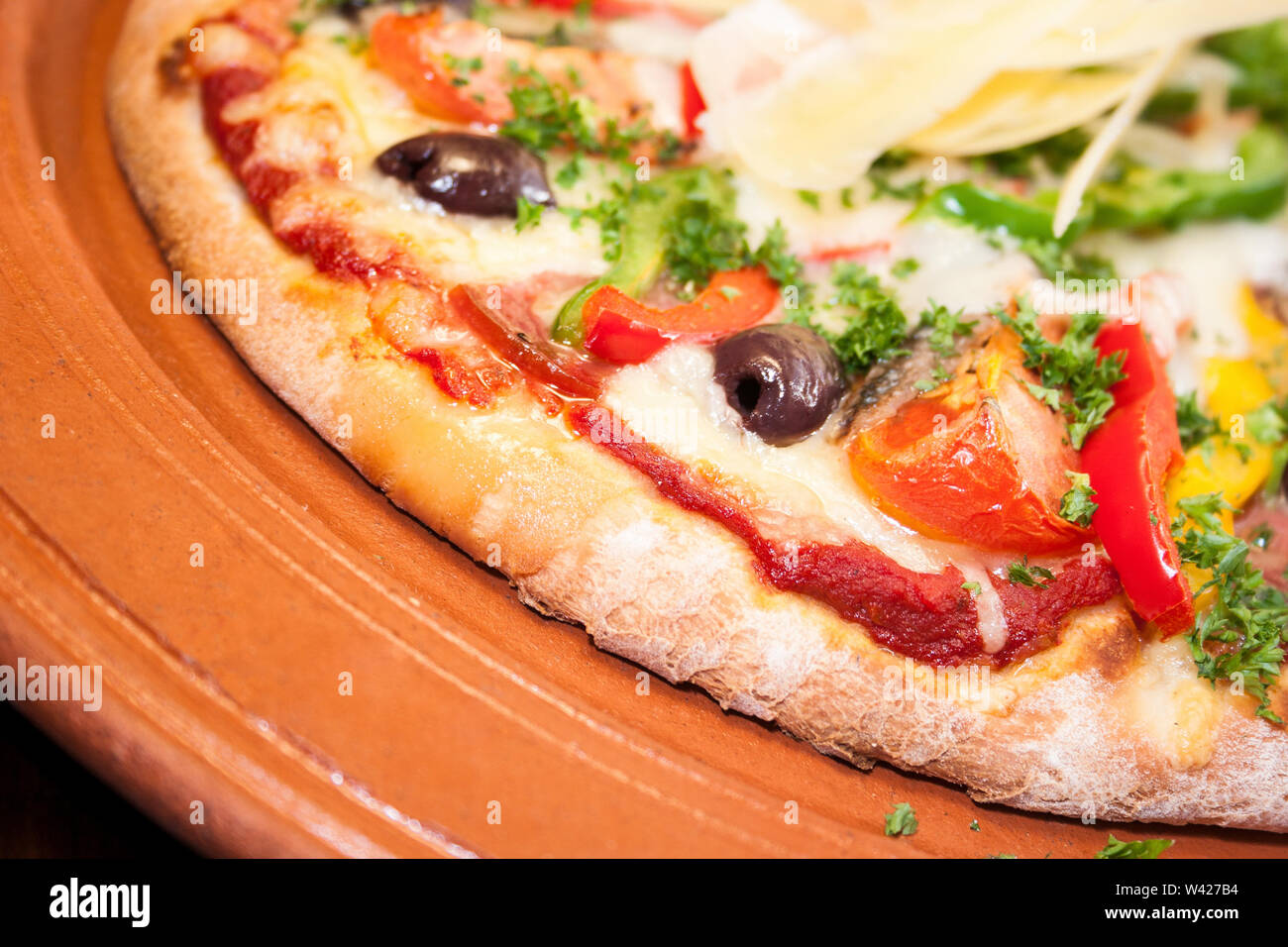 Yummy pizza with vegetables and cheese, ceramic plate with food on