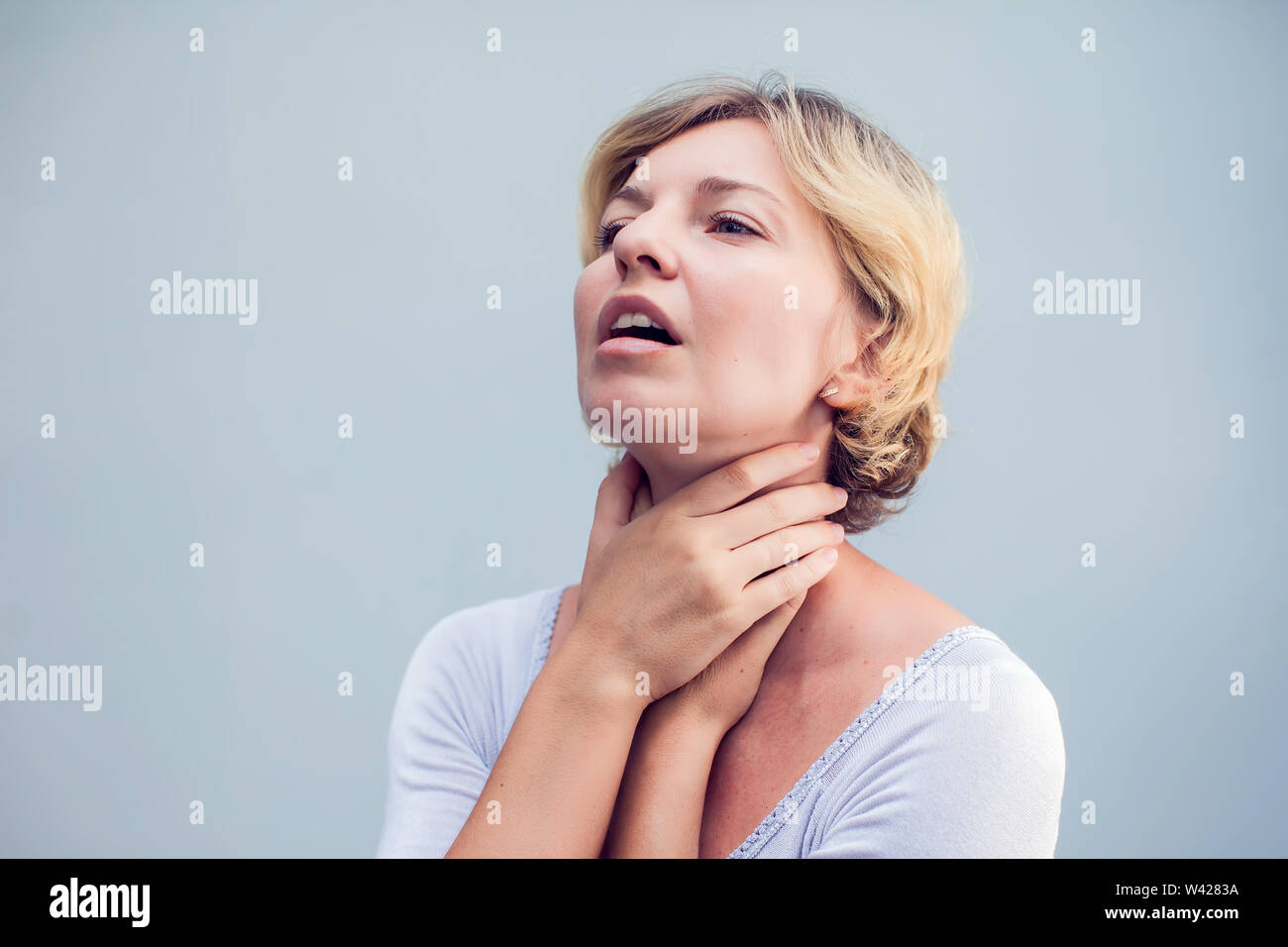 Throat Pain. Closeup Of Sick Woman With Sore Throat Feeling Bad, Suffering From Painful Swallowing. Beautiful Girl Touching Neck With Hand. Illness, H Stock Photo