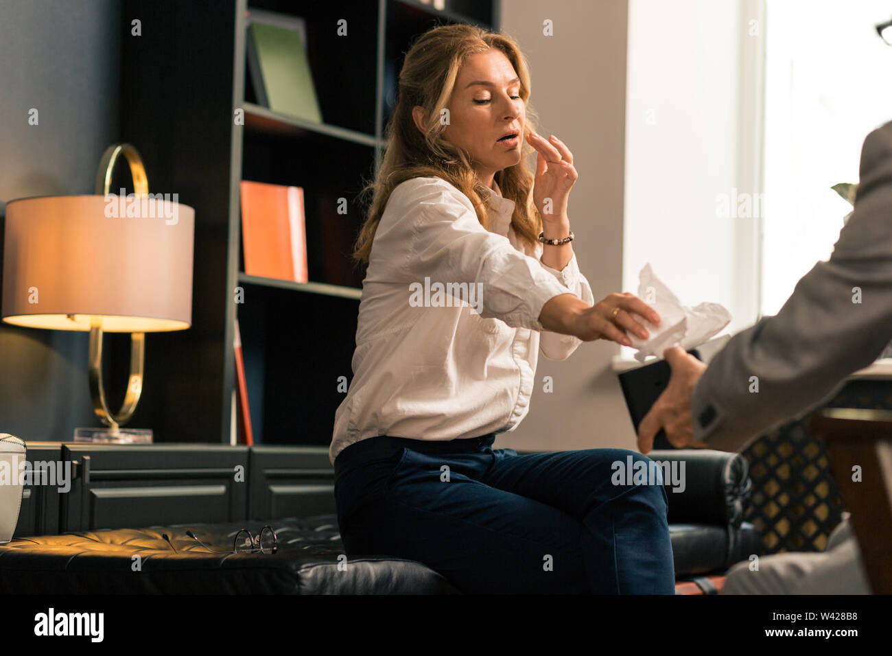 Distressed woman unburdening her heart to a psychotherapist Stock Photo