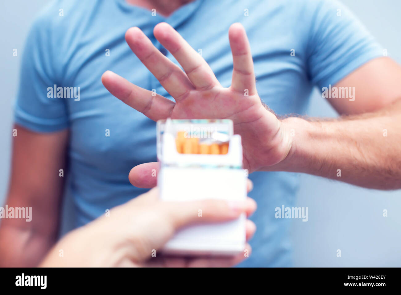 Man refusing a cigarette from a pack of smokes concept for quitting ...